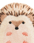 The Hedgehog Embroidery Kit by Faire features a cute hedgehog with brown and tan quills, round eyes, dark nose, and pink feet on a white background—ideal for DIY projects or as a charming pattern.