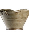 The Zentique Grey Ceramic Pot features a handcrafted design with a wavy rim, twisted decorative handle, subtle horizontal lines, and an uneven organic shape for a unique look.