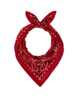 The Silk Bandana by The Great Inc. features soft red silk with a paisley pattern in black and white on a white background, tied in a knot at the top to form a loop.