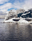 A modern dark cabin by a snowy lake, inspired by mountain houses and curated interiors, is nestled among trees and distant mountains; text reads "Mountain House by Random House.