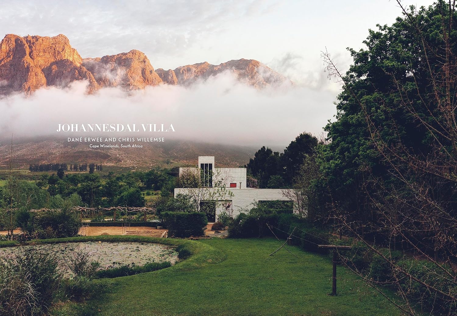 A modern white villa inspired by mountain houses rests among gardens and peaks, shrouded in drifting clouds. Text overlay: "Mountain House" by Random House, with interior design by expert Nina Freudenberger.