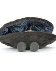 The Amuseables Michelle Mussel by Jelly Cat Inc. is a plush toy shaped like a dark gray clam with a velvety interior and two small, ridged feet, shown on a white background.