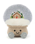 The Jelly Cat Inc. Amuseables Snow Globe is a plush mushroom toy with a fluffy cap, embroidered cabin and pine trees, smiley face, round black eyes, and gray feet—a whimsical après ski or ski gift!.