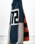 The CanyonKid 72' Cashmere Lux Crew by Free City (sparrow, LLC) is a unisex color-blocked sweater with blue, beige, orange, and maroon stripes, a bold "72" on the chest, and the "art commerce" logo in the lower-left corner.