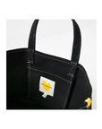 The Tote Imperfect Heart by Kerri Rosenthal is a cotton canvas bag with white stitching, featuring a small white label inside adorned with a yellow Imperfect Heart and black text. This stylish black tote has two sturdy handles and is artfully positioned against a neutral backdrop.