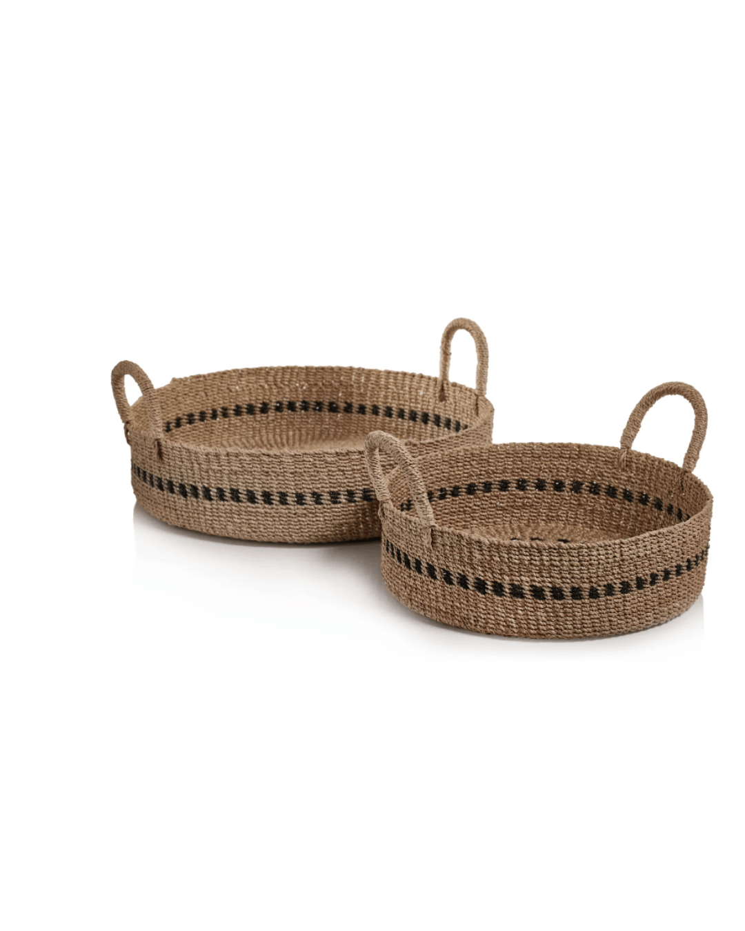 Two Abaca Basket Trays with handles, featuring a natural beige color and decorated with a simple dark brown stripe pattern, displayed against a white background in a Scottsdale, Arizona bungalow by Zodax.