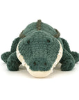 The Allexi Alligator by Jelly Cat Inc. is a green plush toy with textured, corduroy-like fabric and a soft, cream-colored snout—perfect for veggie Southern cuisine fans or as playful Louisiana diner decor. Lies flat with head forward.