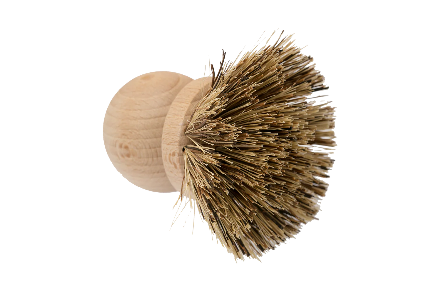 The Be Home Saucepan Brush is a round wooden kitchen brush with stiff, natural vegetable fiber bristles, inspired by timeless design and photographed against a plain white background.