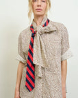 A woman in the oversized Dear Polly Bow Blouse by Aquarius Cocktail stands against a plain light background, looking directly at the camera.