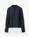 The Rag & Bone arden pleated blouse features long sleeves, a round neckline, feminine ties at the collar and cuffs, and front pleats, shown in black on a plain white background.