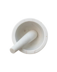 The Creative Co-op Marble Mortar & Pestle features a classic design with a smooth, polished white marble finish. The pestle elegantly sits inside the shallow mortar, all set against a plain white background when viewed from above.
