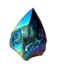 The Blue Ocean Traders Aura Black Obsidian Point is a polished sculptural crystal with glossy surfaces and subtle blue, green, and purple sheen—an artful mineral display set against a white background.
