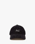 The Clare Vivier Baseball Hat S25 is a black corduroy cap with "Oui" embroidered in white cursive on the front, perfect for subtle style. Shown on a plain white background.