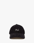 The Clare Vivier Baseball Hat S25 is a black corduroy cap with "Oui" embroidered in white cursive on the front, perfect for subtle style. Shown on a plain white background.