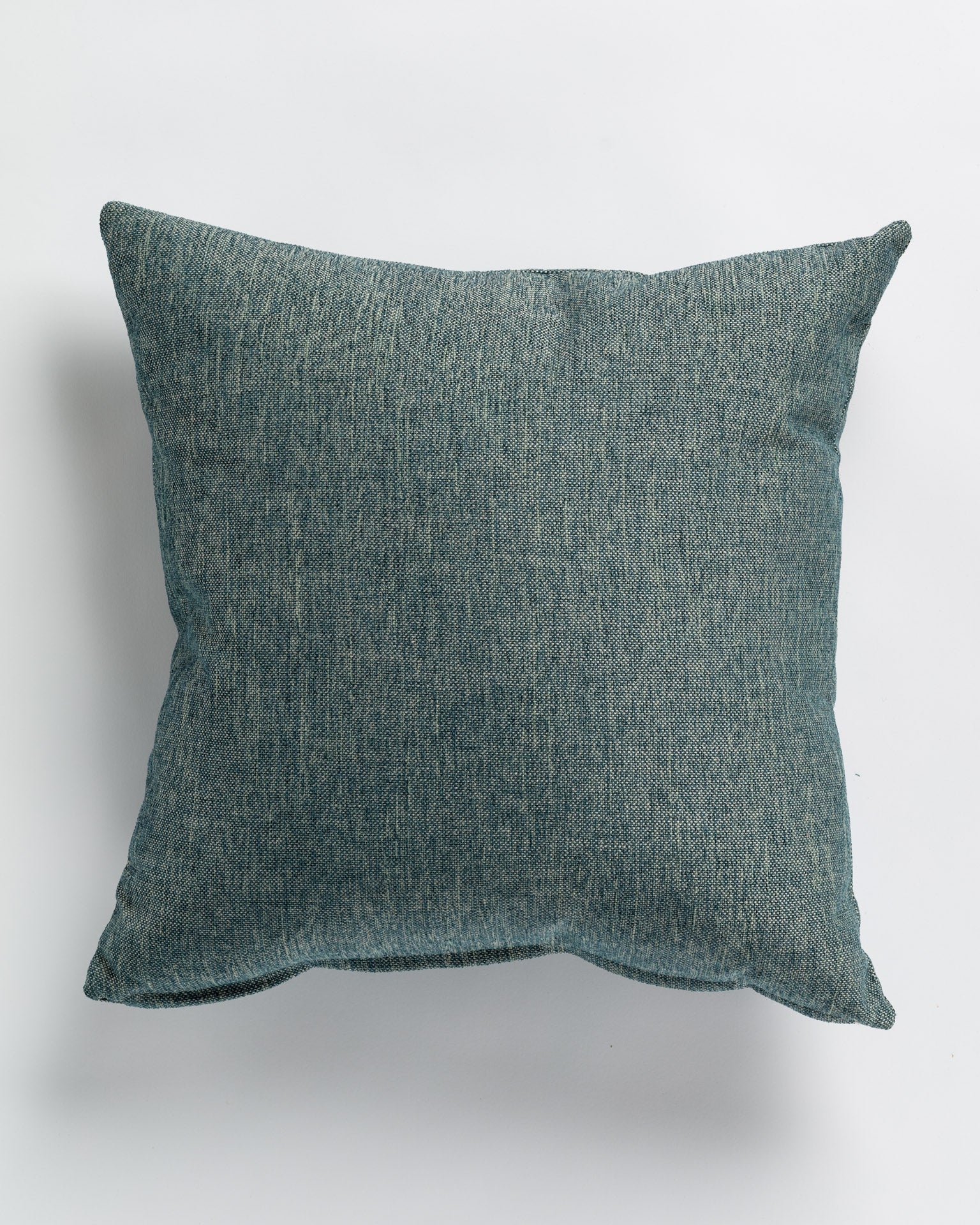 The Gabby Binds Haze Gr-4 Pillow 26x26 is a square teal pillow with a textured fabric surface, custom made for the Bungalow Exclusive collection and set against a white background.