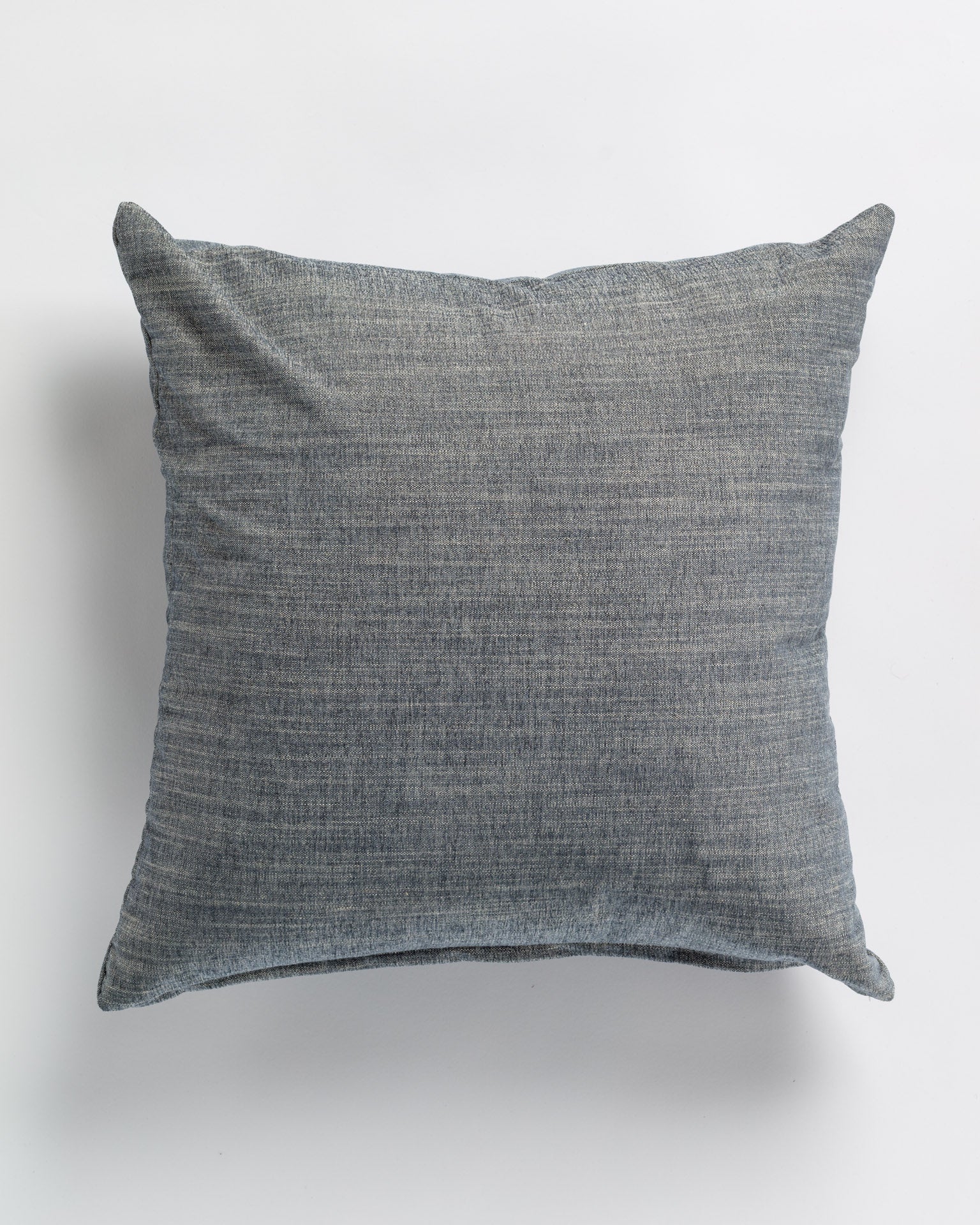 A Carter Nordic Pillow 26x26" from Gabby, with a fine texture, displayed against a plain white background in a Scottsdale Arizona bungalow. The pillow is plump and square-shaped, featuring visible stitching along the edges.
