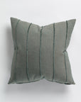 The Gabby Hilo Stripe Blue Spruce Gr-3 Pillow 26x26 offers elegance and comfort with its square gray design featuring vertical textured stripes. The soft fabric adds sophistication, making it perfect for minimalist aesthetics against a plain white background.