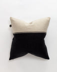 The Marshall Pillow by Libeco Home is a square throw pillow with a classic two-tone design in cream and black, separated by a thin line. Made of luxurious linen and wool, it is elegantly displayed against a plain white background.