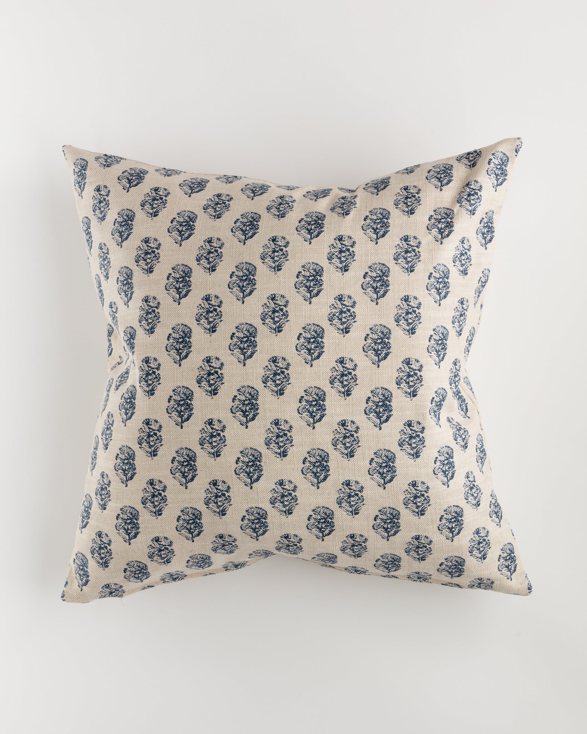 A luxurious Pindler Custom 1 Pillow 28x28, featuring a beige background adorned with a repeating pattern of blue floral designs, complete with a plush pillow insert, is showcased against a plain white backdrop.
