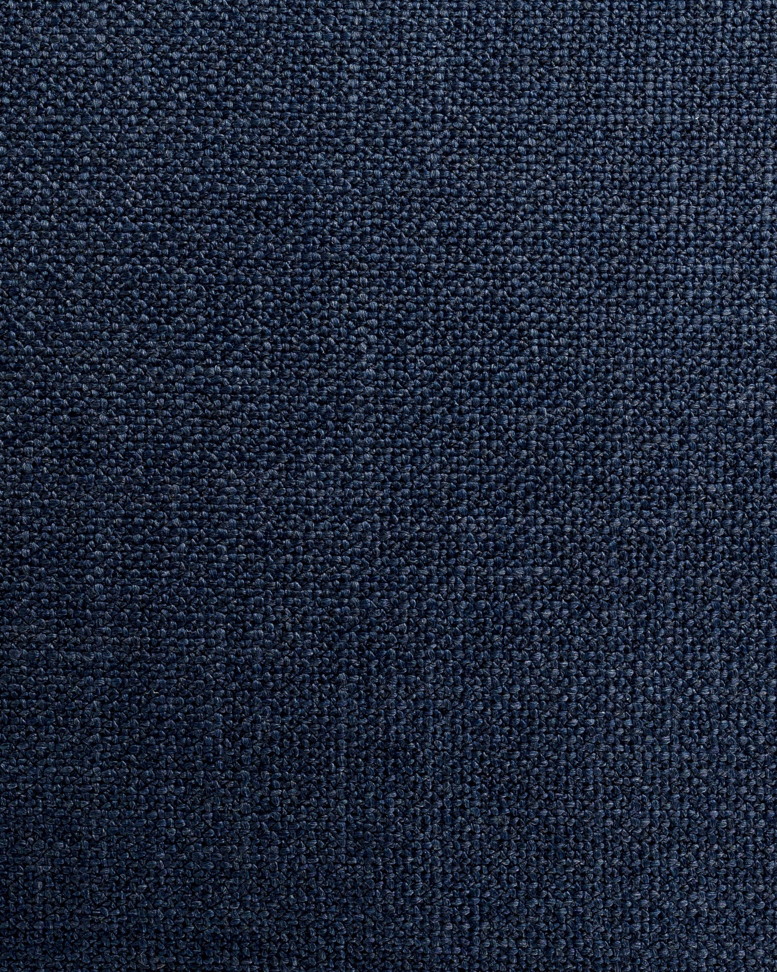 Close-up texture of a dark blue denim fabric, showing detailed Arizona-style weave patterns with visible threads in varying shades of blue Gabby Bermuda Blue Pillow 26x26.
