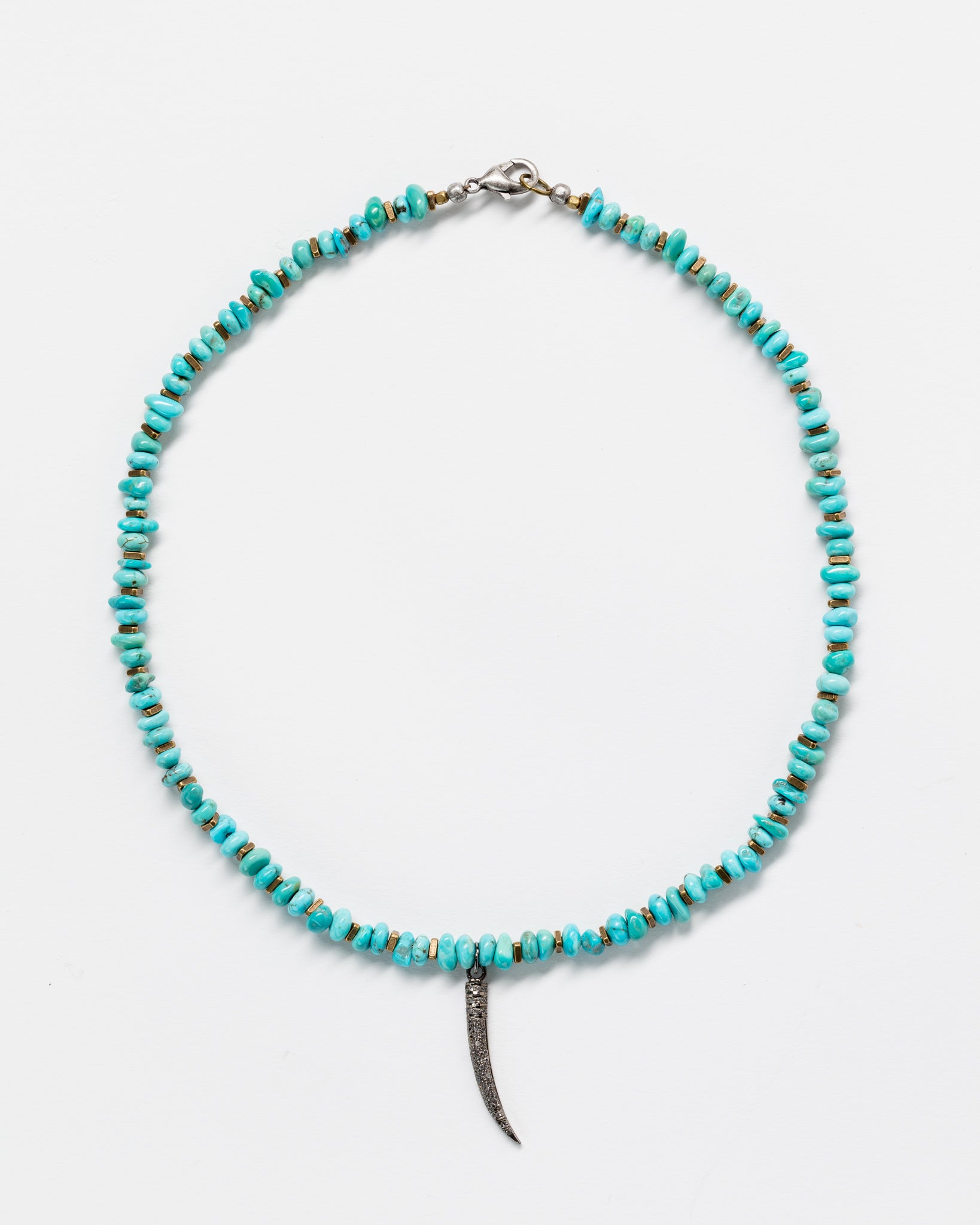 A necklace featuring a sequence of vibrant Designs By Raya turquoise beads with a metallic silver clasp, complemented by a slender, curved pendant resembling a horn or tusk, against a plain white background.