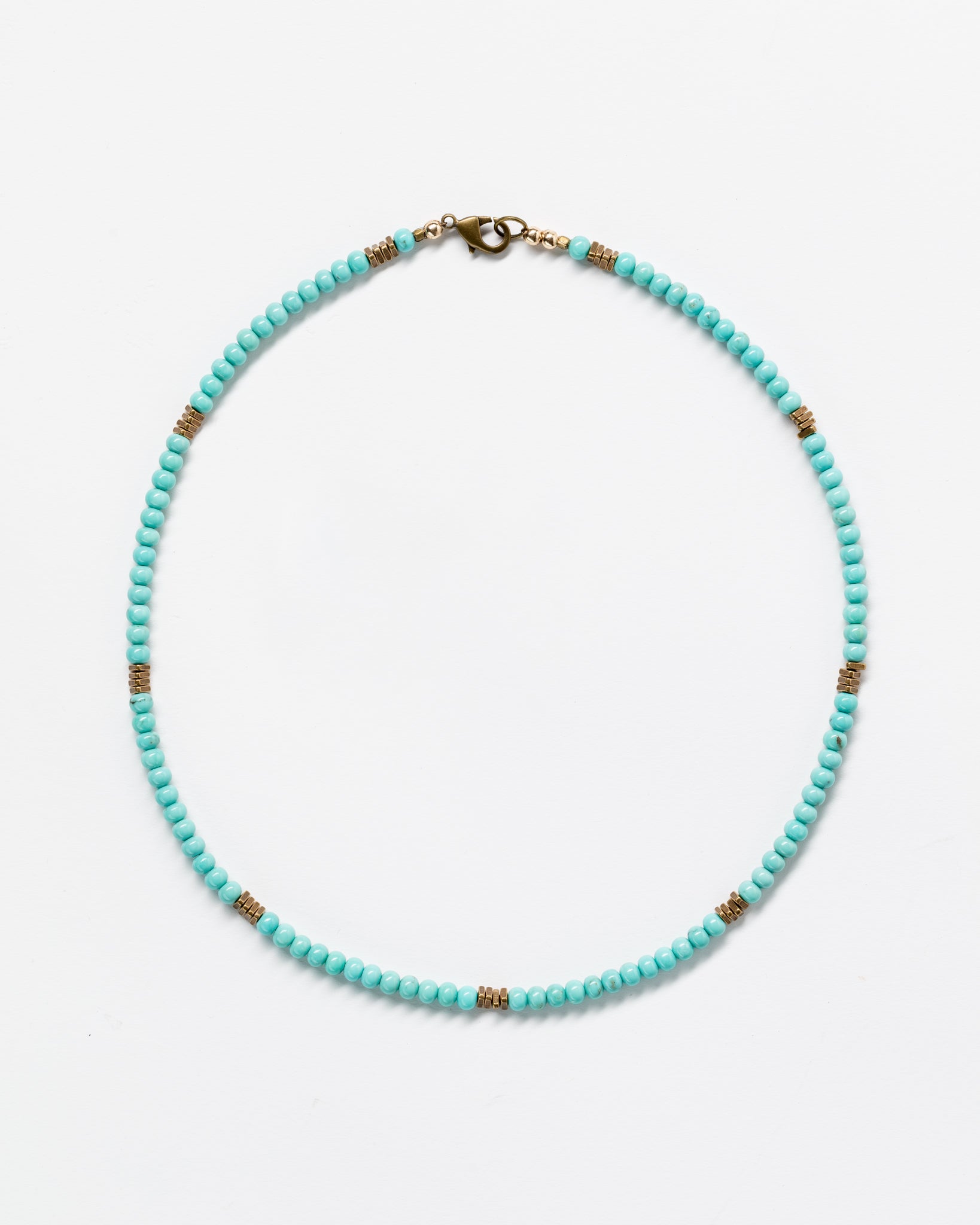 A Designs By Raya turquoise beaded necklace with intricate gold accents arranged intermittently, displayed against a plain white background, embodying Arizona style.
