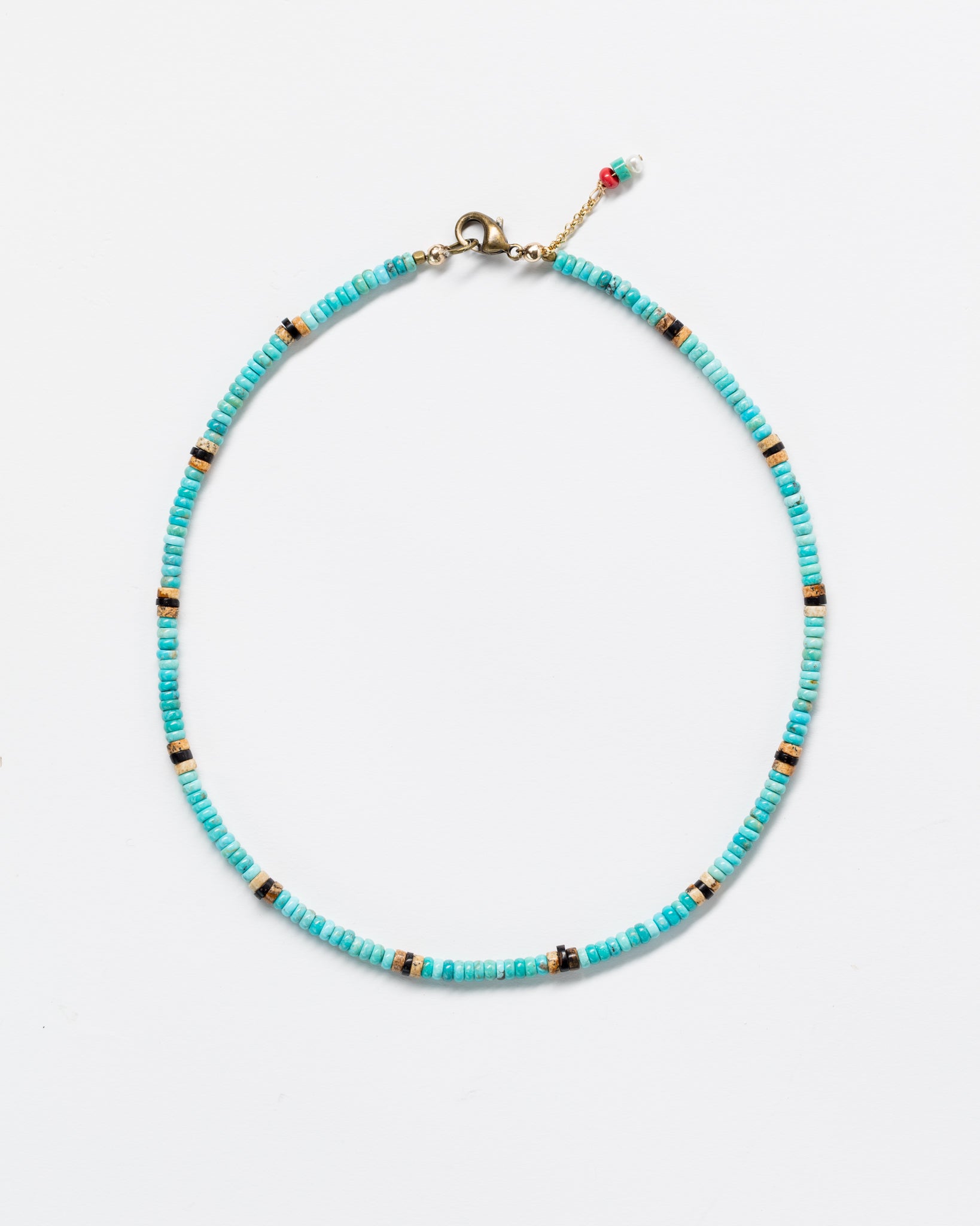Turquoise Designs By Raya necklace displayed against a white background, featuring a delicate gold clasp with a small Arizona-style charm.