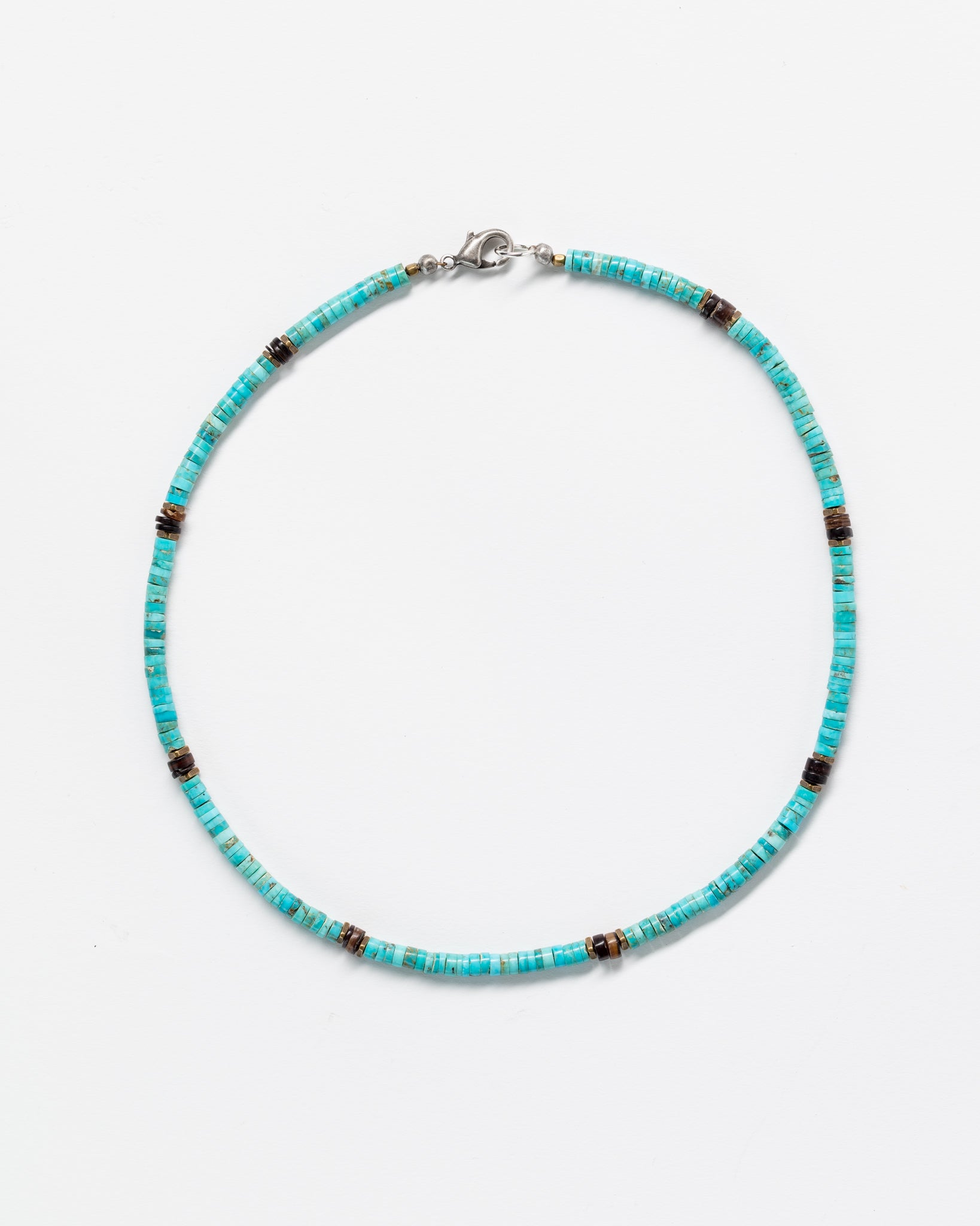 A Designs By Raya turquoise necklace with black and metallic accents, displayed against a white background. The necklace features a simple clasp and embodies Arizona style.