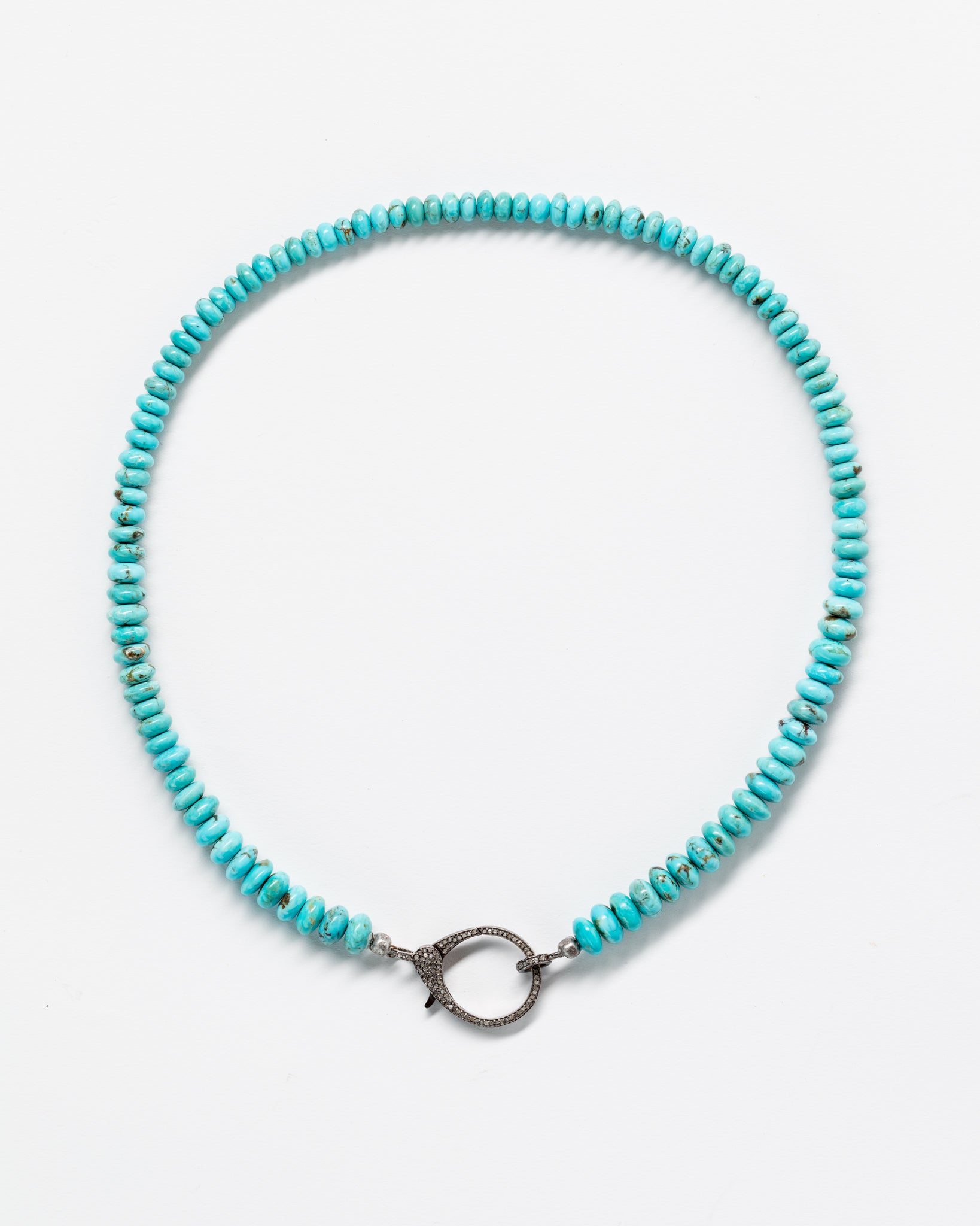 A beautiful Designs By Raya Arizona turquoise bead necklace displayed on a white background. The necklace features a circular silver clasp at its center.