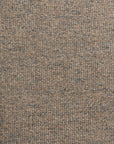 Close-up of a woven fabric with a tight, interlocking pattern. The Idgie Blue Spruce 24x24" pillow features a mixture of brown and gray threads, creating a textured and slightly speckled appearance. This Gabby exclusive captures the intricate details and variations in color and weave perfectly.