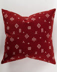 The elegant Custom 1 Pillow 28x28 from Pindler features a rich maroon color adorned with white geometric tribal patterns on a plain background. The detailed designs, such as diamond shapes and crosses, enhance its decorative allure. Ideal for a euro pillow setup, it comes with a comfortable pillow insert for extra coziness.