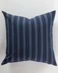 The Custom 3 Pillow 28x28 by Pindler provides both comfort and support with its luxurious design featuring dark blue and light blue vertical stripes on a white background. Its symmetrical pattern and soft, woven texture contribute to an elegant appeal.