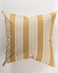 The Pindler Custom 4 Pillow 28x28 features a mustard yellow base adorned with intricate white floral patterns and vertical stripes, offering extra comfort. Its symmetrical design is ideal for layering on a light, smooth background.