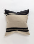 The Marshall Pillow by Libeco Home offers a timeless, minimalist design with black and off-white horizontal stripes on a light background. Made of luxurious linen and wool, its center is predominantly light and framed by two dark sections at the top and bottom.