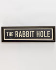 A rectangular black and white "Street Sign In Black" by Spicher And Company is framed and displayed as unique wall decor against a plain white background.