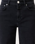 Close-up of a person wearing the CLOSED Glow Up high waist black denim jeans with button and zipper closure, belt loops, and front pockets. These jeans feature a classic five-pocket design and a straight-leg silhouette.
