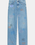 The Nikka Denim by CLOSED offers a relaxed fit in light blue eco-conscious denim, detailed with colorful "CLOSED" stamps, text designs, front pockets, belt loops, and a button closure.
