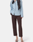 Light blue CLOSED Souki shirt and mid-rise wool-blend trousers styled with a black scarf and sandals on white background.