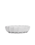 A minimalist white ceramic Bowl No. 727 shaped like a stylized set of human teeth, isolated on a plain white background in a Scottsdale, Arizona bungalow by Montes Doggett.