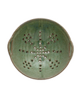 The Berry Bowl by Creative Co-op is a rustic green stoneware piece with side handles and a star-shaped pattern of holes in the center, shown from above.