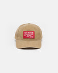 The CLOSED Cap is tan cotton with a curved brim and washed finish, featuring a bold red and white rectangular "CLOSED PRODUTTORE DI JEANS DAL 1978" patch on the front. An adjustable strap provides a comfortable fit. Plain white background.