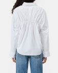 A person shown from behind wearing the CLOSED Gathered Shirt, a relaxed-fit white blouse with back gathers, paired with blue jeans.
