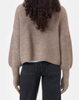 CLOSED funnel neck long sleeve jumper in dark color, back view, modeled with curly hair by Bungalow Furniture & Accessories.