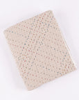 Beige handmade quilt with textured surface and colorful geometric dots by Amity Home, Mendel collection.