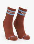 Blue-striped tube socks with bold cuff text by Mother, style Baby Steps, set on a clean white background.