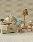 Maileg Dance Mouse Little Sis sits in a daybed, reaching toward a tea table; whimsical nursery decor by Maileg.