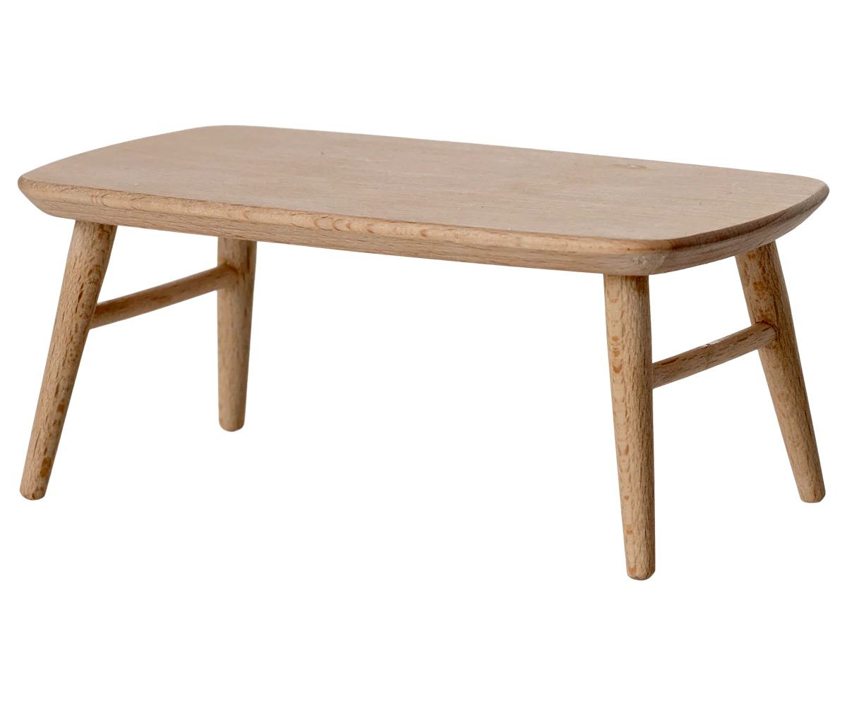 The Maileg Furniture by Maileg is a charming small wooden table with four angled legs and a smooth rectangular top, ideal as dollhouse furniture for your Maileg Mouse. Displayed against a plain white background.