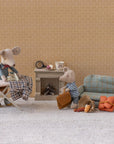 Maileg Granddad Mouse by Maileg features two fabric mice in a miniature living room, with magnetic paws for ironing and suitcase-holding. Includes sofa, fireplace, tea set, lantern, basket, food items, and more tiny accessories.