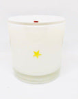The Fritz & Troy Sweet & Salty Candle is made of white coconut/soy wax in a clear glass holder with a small yellow star on the front, shown against a plain white background.