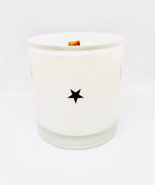 The Fritz & Troy Wild Child Candle is a white coconut/soy wax candle in a glass jar with a wooden wick and a single black star on the front, shown against a plain white background.